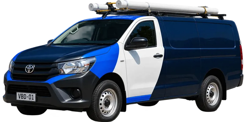 A licensed Epping plumbing van loaded with pipe on the roof rack